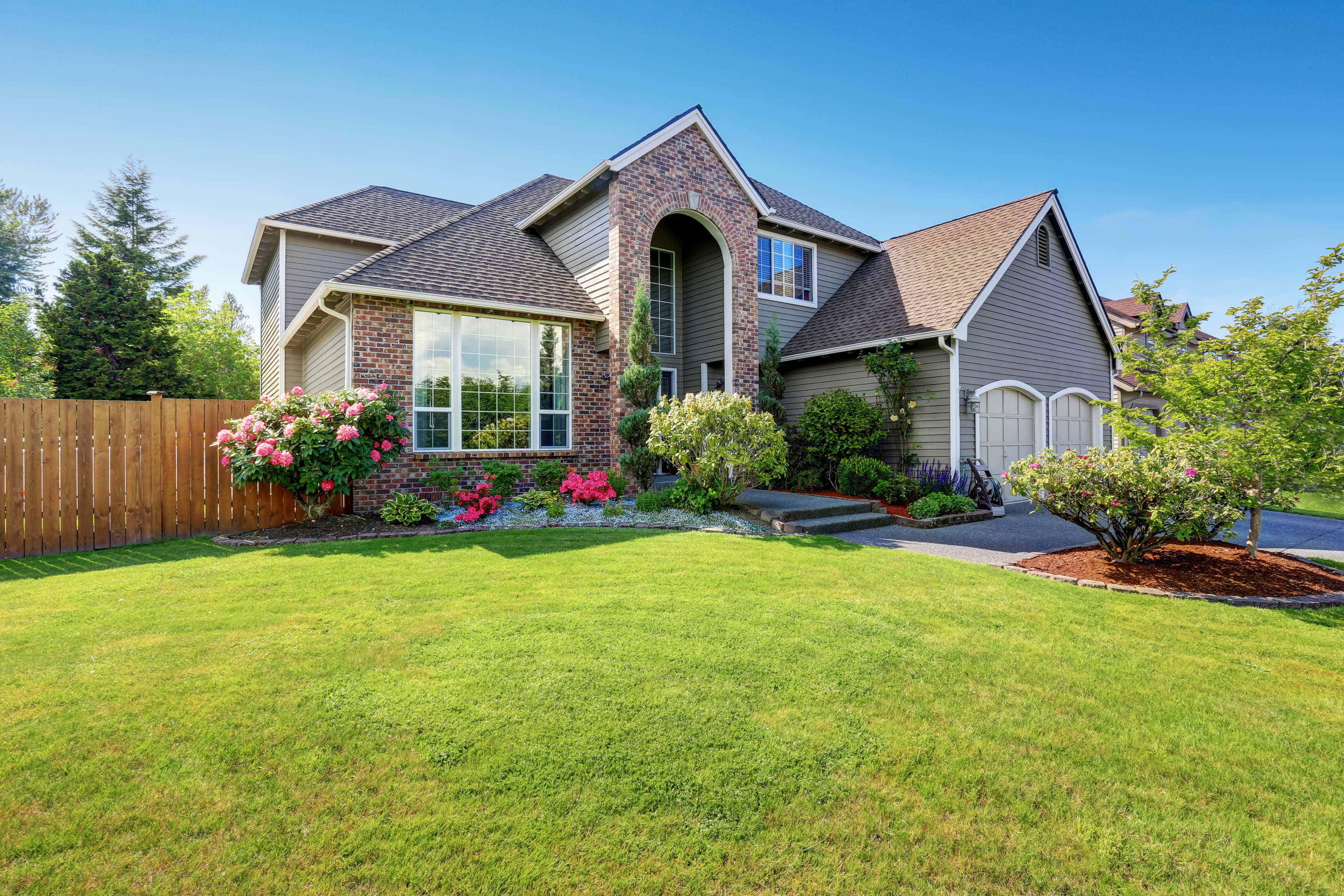 Beautifully maintained lawn and landscaped home exterior